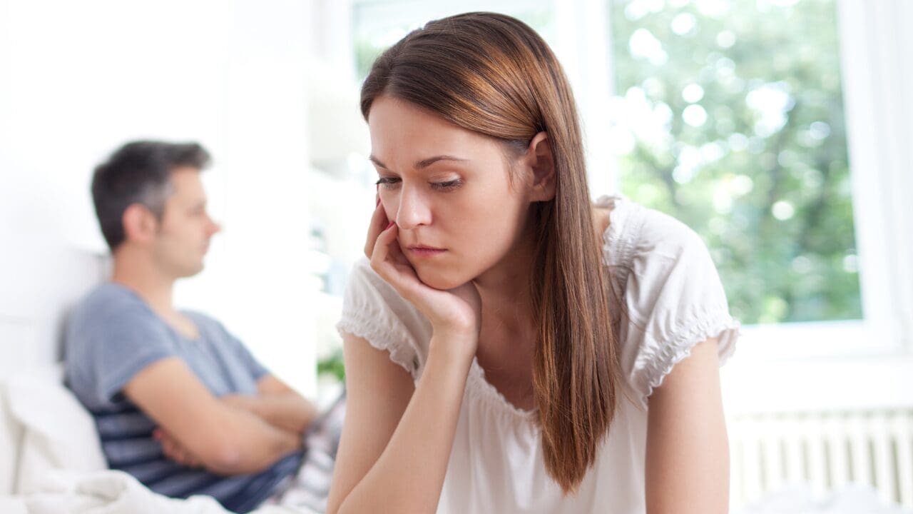Woman sitting, thoughtfully reflecting on her relationship and life situation.