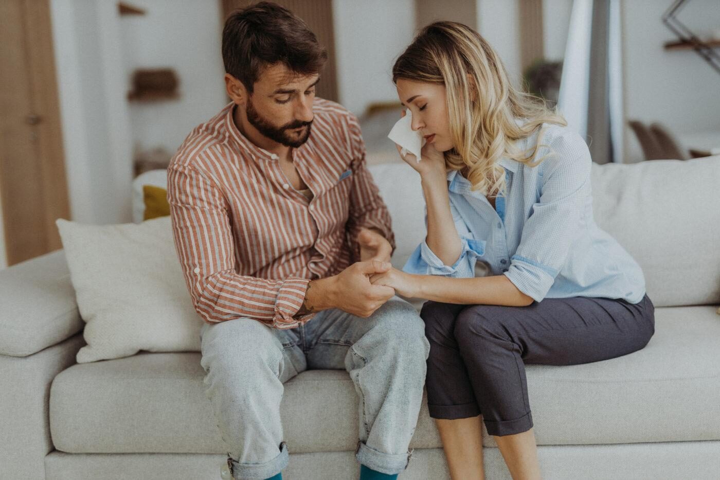 Couple sitting together after a conflict and having an honest conversation to rebuild trust in their relationship.