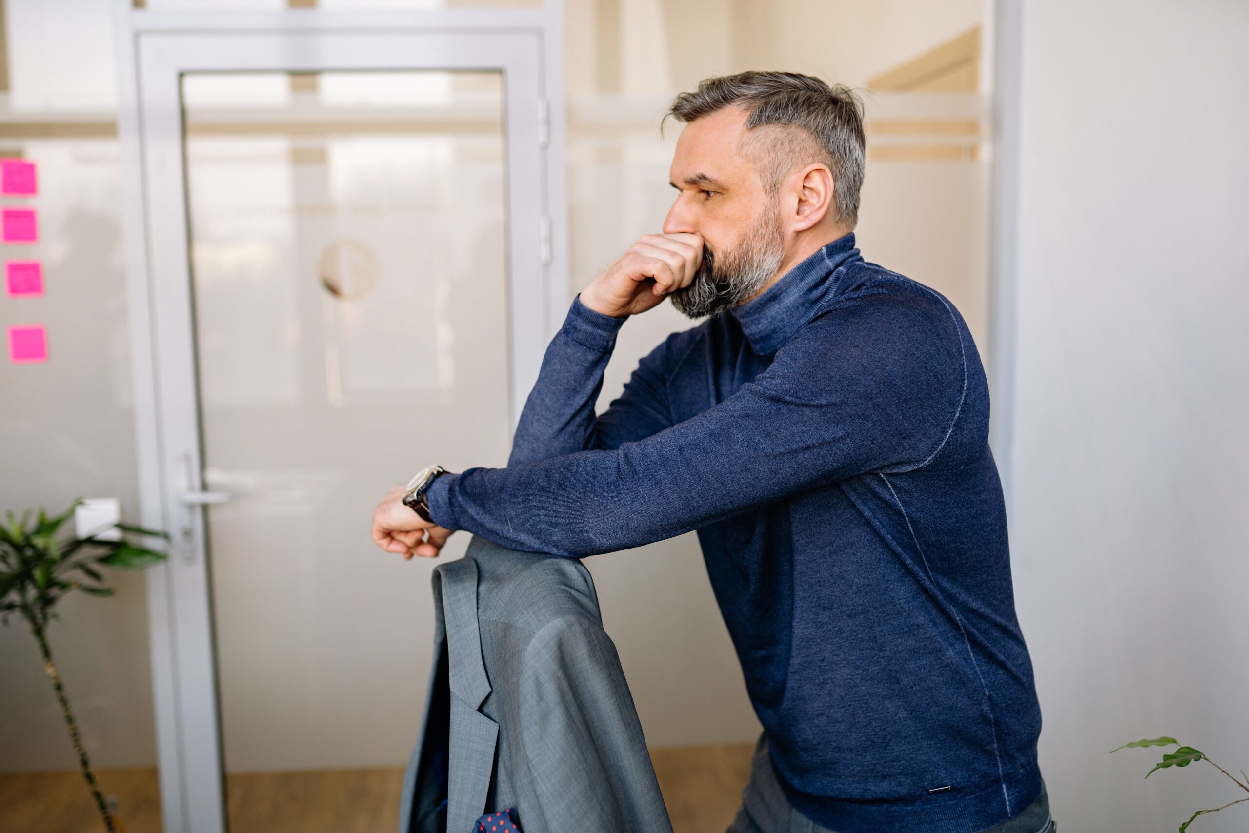 Worried man thinking about a difficult decision and feeling uncertain about which path to take.